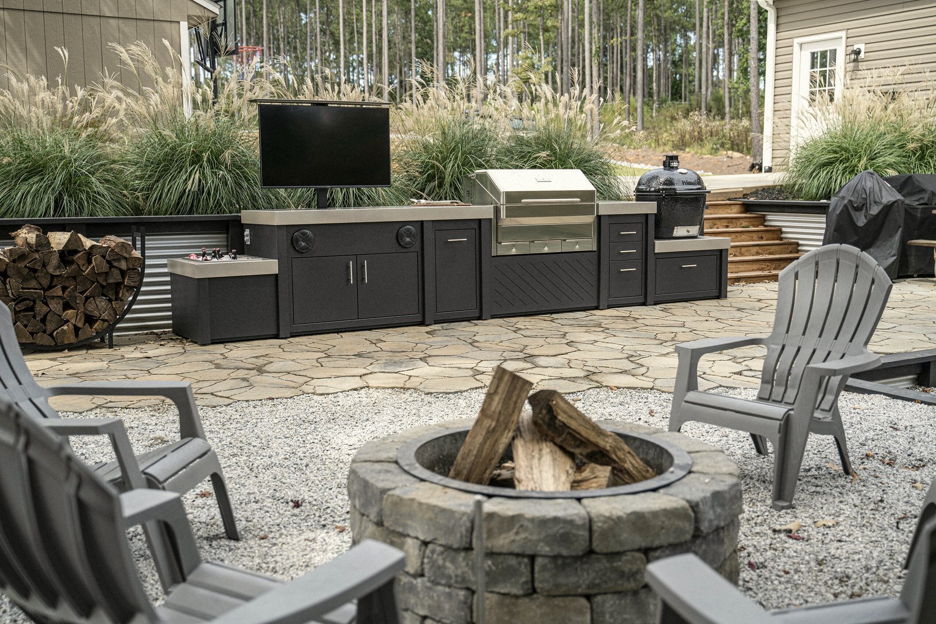 Stone patio with built-in TV · grill and kamado