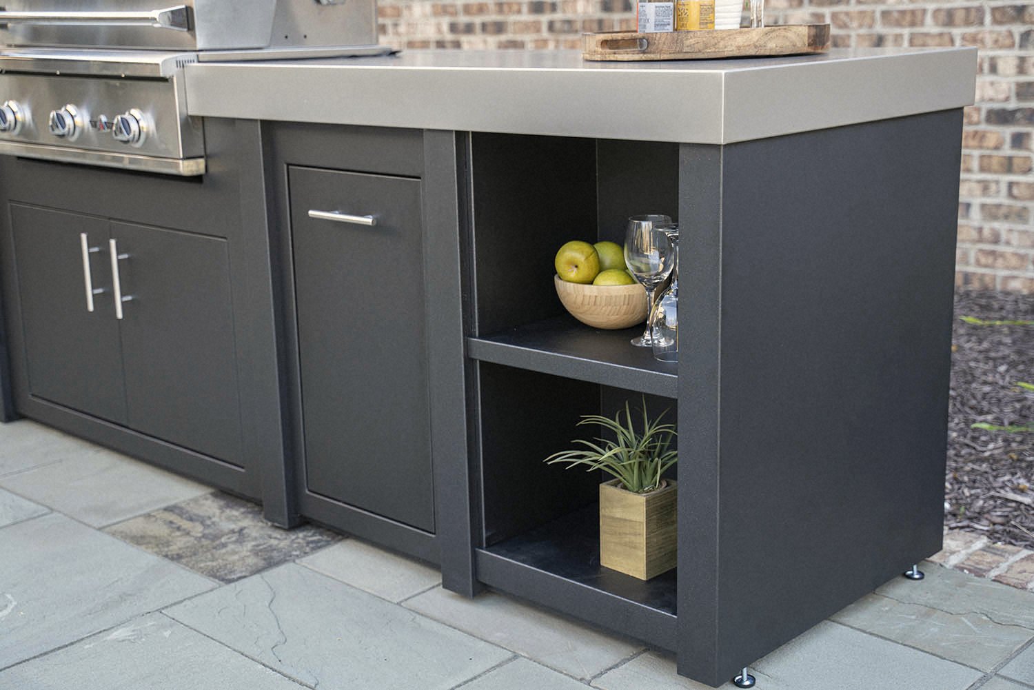 Stainless counter and open shelving · dark cabinetry close-up