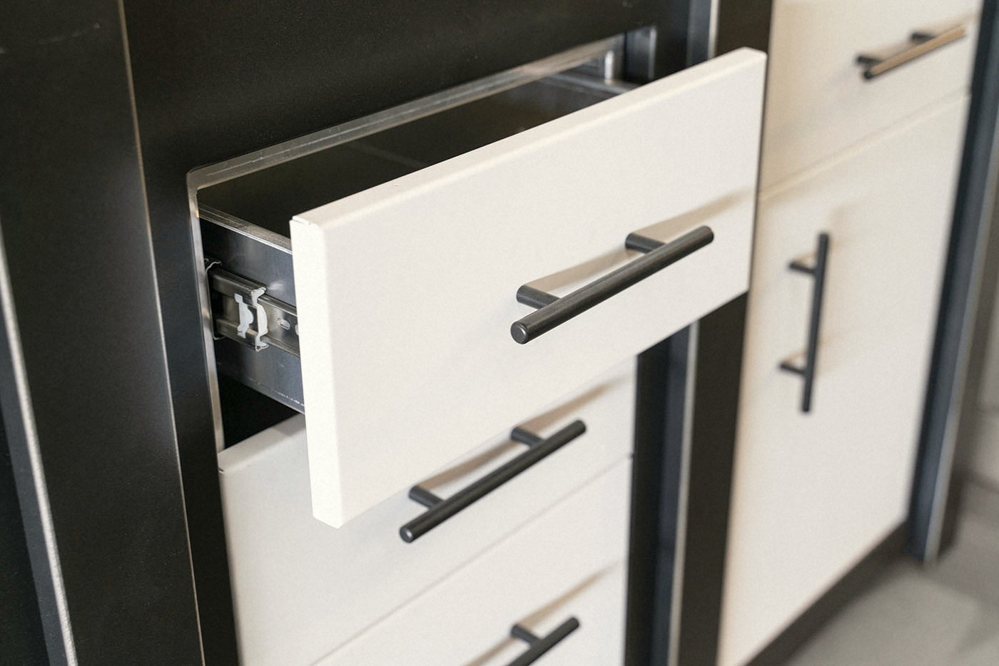 Soft-close drawer detail · matte black hardware