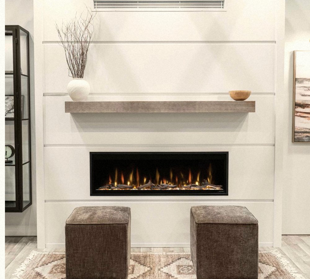 Floating brushed-beige shelf and linear gas fireplace on a white V-Groove paneled wall.